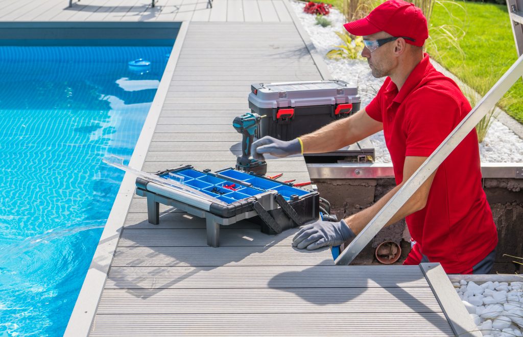 a person in red uniform by a pool